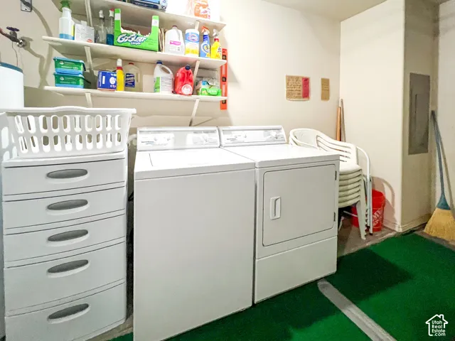 Utility area featuring wall-mounted shelving and a dedicated electrical service panel