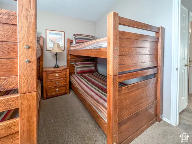 Room featuring neutral wall tones, textured carpeting, and a standard interior door