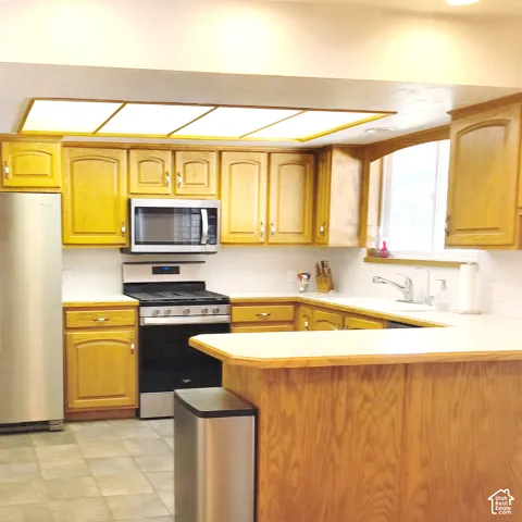Kitchen featuring wood cabinetry & stainless steel appliances,