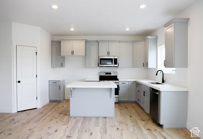 Kitchen with island and quartz countertops