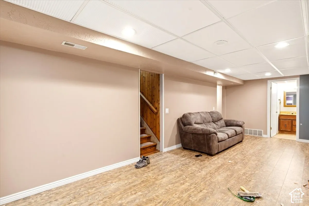 Finished interior space featuring wood-finish flooring, recessed lighting, and a drop ceiling
