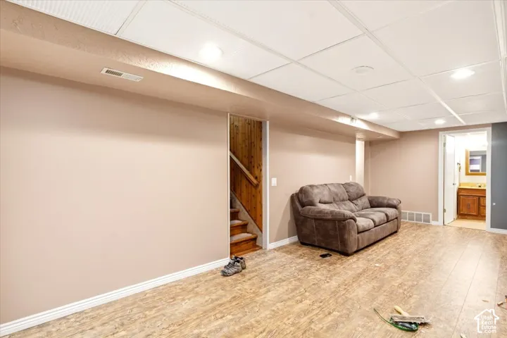 Finished interior space featuring wood-finish flooring, recessed lighting, and a drop ceiling