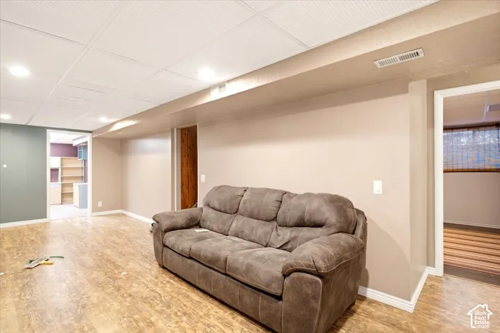 Wood-finish flooring, recessed lighting, and a drop ceiling