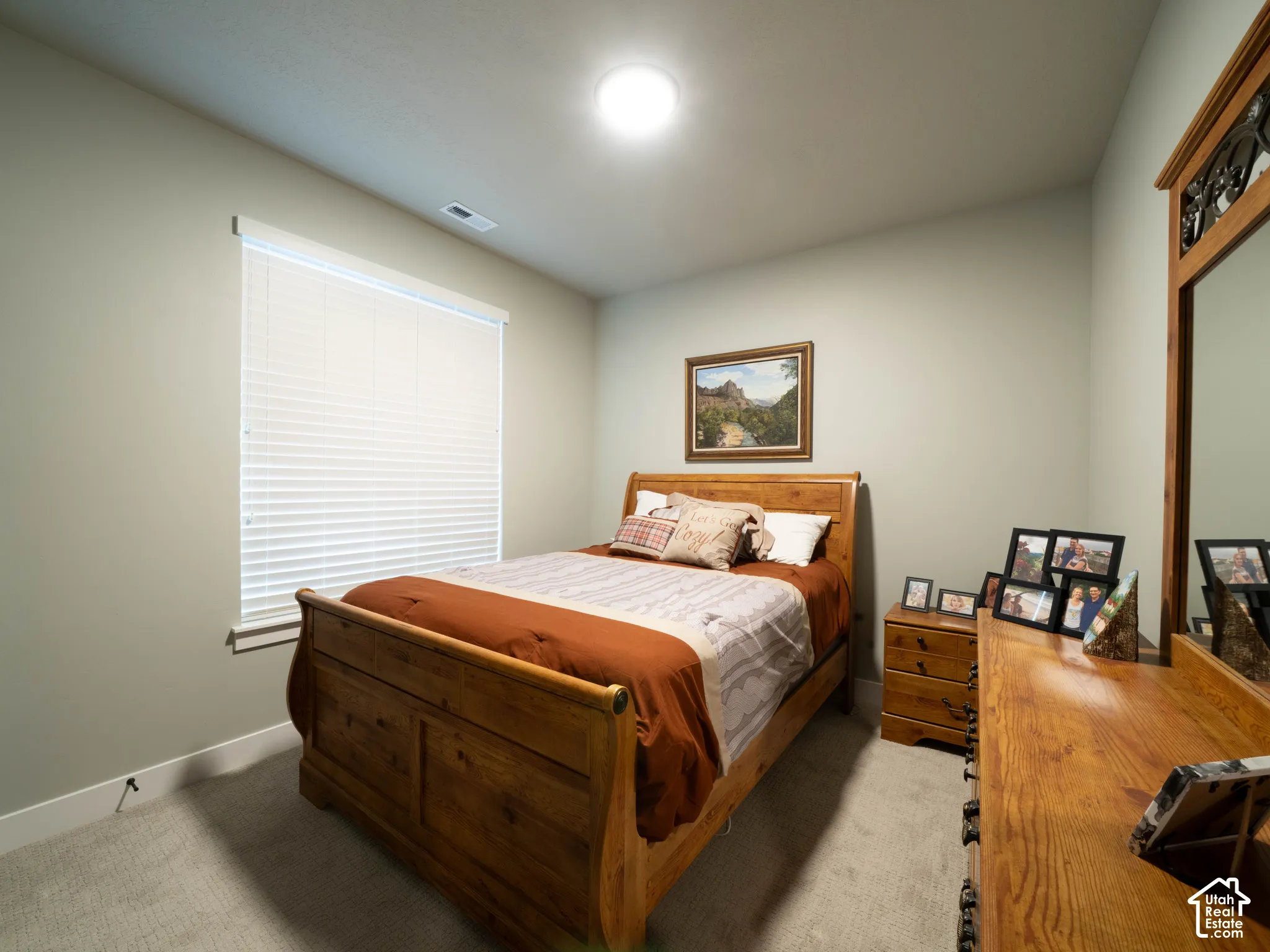 Recessed ceiling lighting, window with blinds, light-toned wall paint, and gray carpet flooring