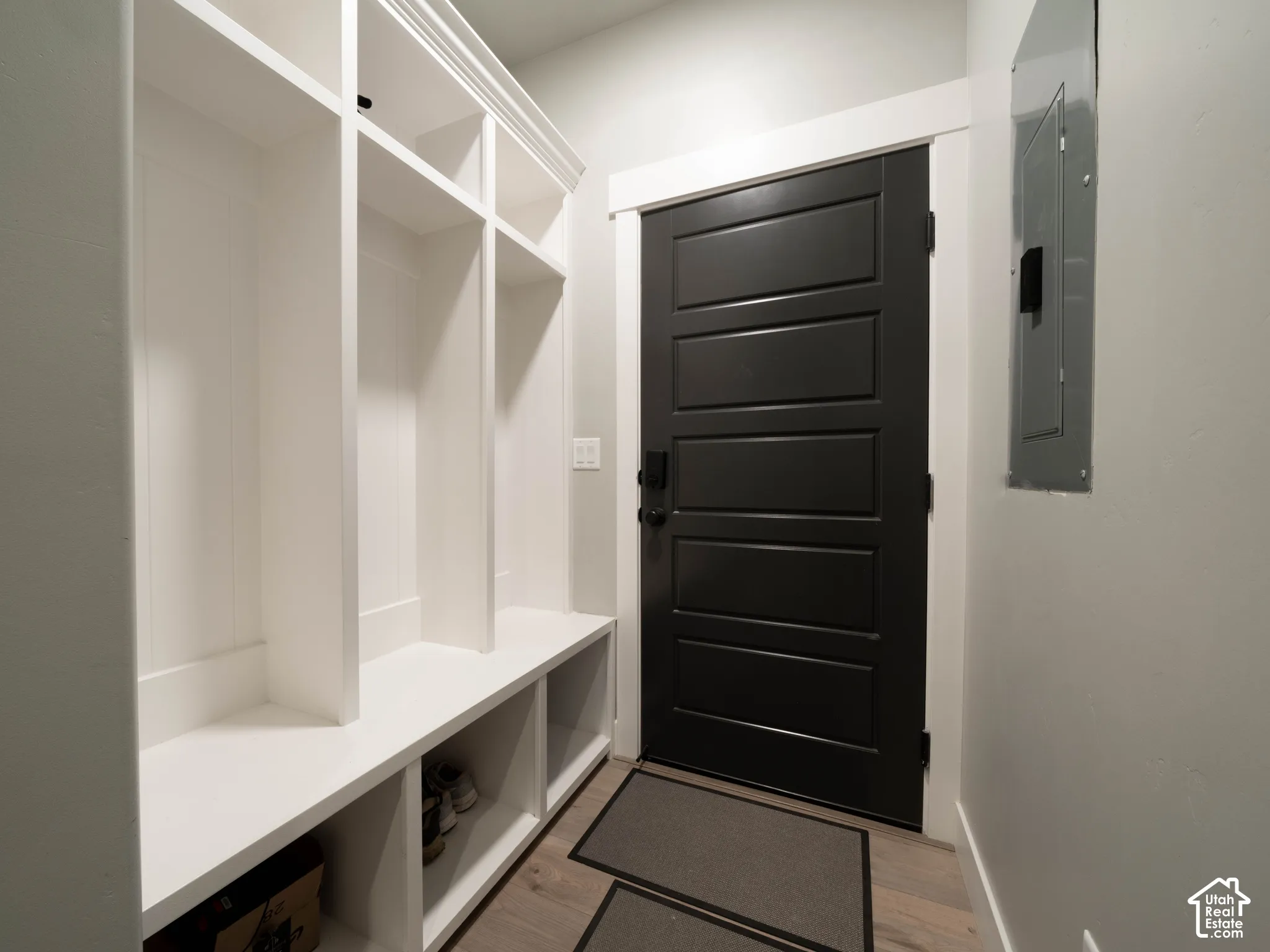 Built-in white storage cubbies with bench seating
