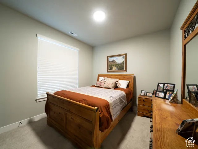 Recessed ceiling lighting, window with blinds, light-toned wall paint, and gray carpet flooring