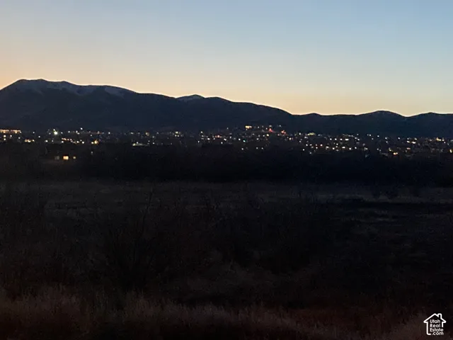 View from the backyard at night. Expansive mountain backdrop with ridgeline silhouettes and horizon-spanning terrain
