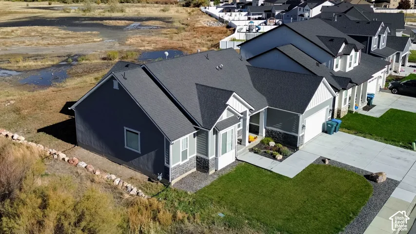 Modern ranch-style residence featuring a dark gray roof, two-car garage, and a concrete driveway