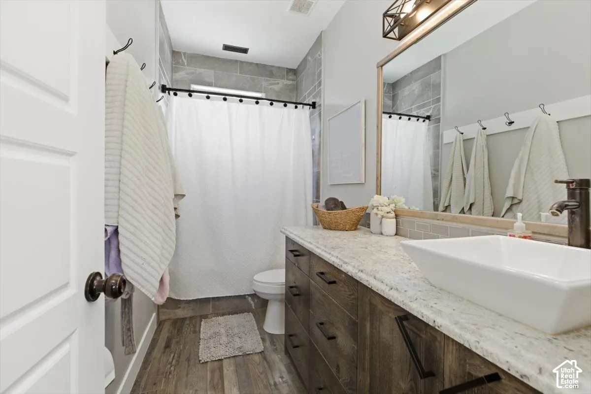 Bathroom vanity with a stone countertop, rectangular vessel sink, and matte black faucet