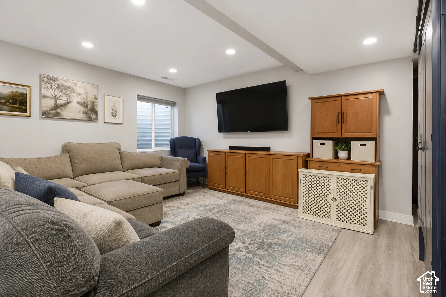Recessed lighting, wood-finish flooring, and a window with an egress well