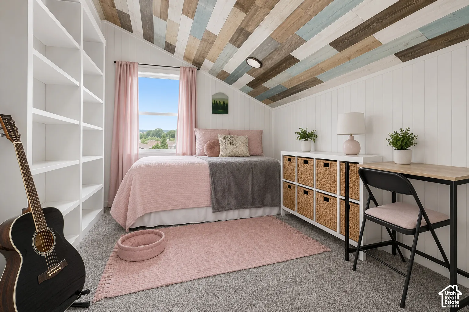 Sloped ceiling with multi-tone wood planking, white vertical paneling, floor-to-ceiling built-in white shelving, and a double-hung window