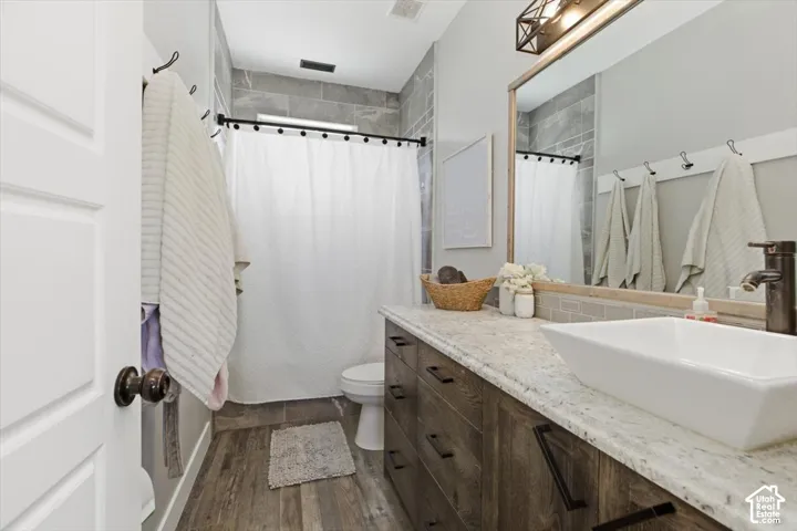Bathroom vanity with a stone countertop, rectangular vessel sink, and matte black faucet