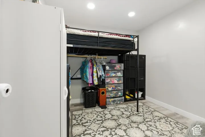 Neutral wall color, wood-finish flooring, and recessed ceiling lighting