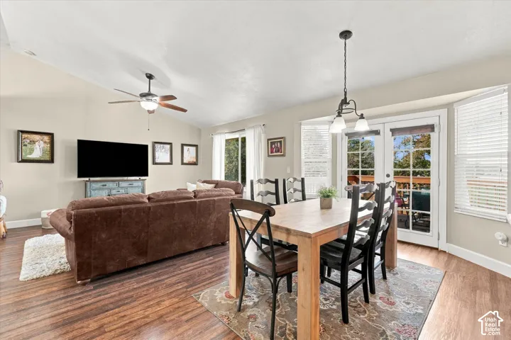 Vaulted ceilings, wood-finish flooring, recessed lighting, ceiling fan with light kit, and French doors featuring glass panes