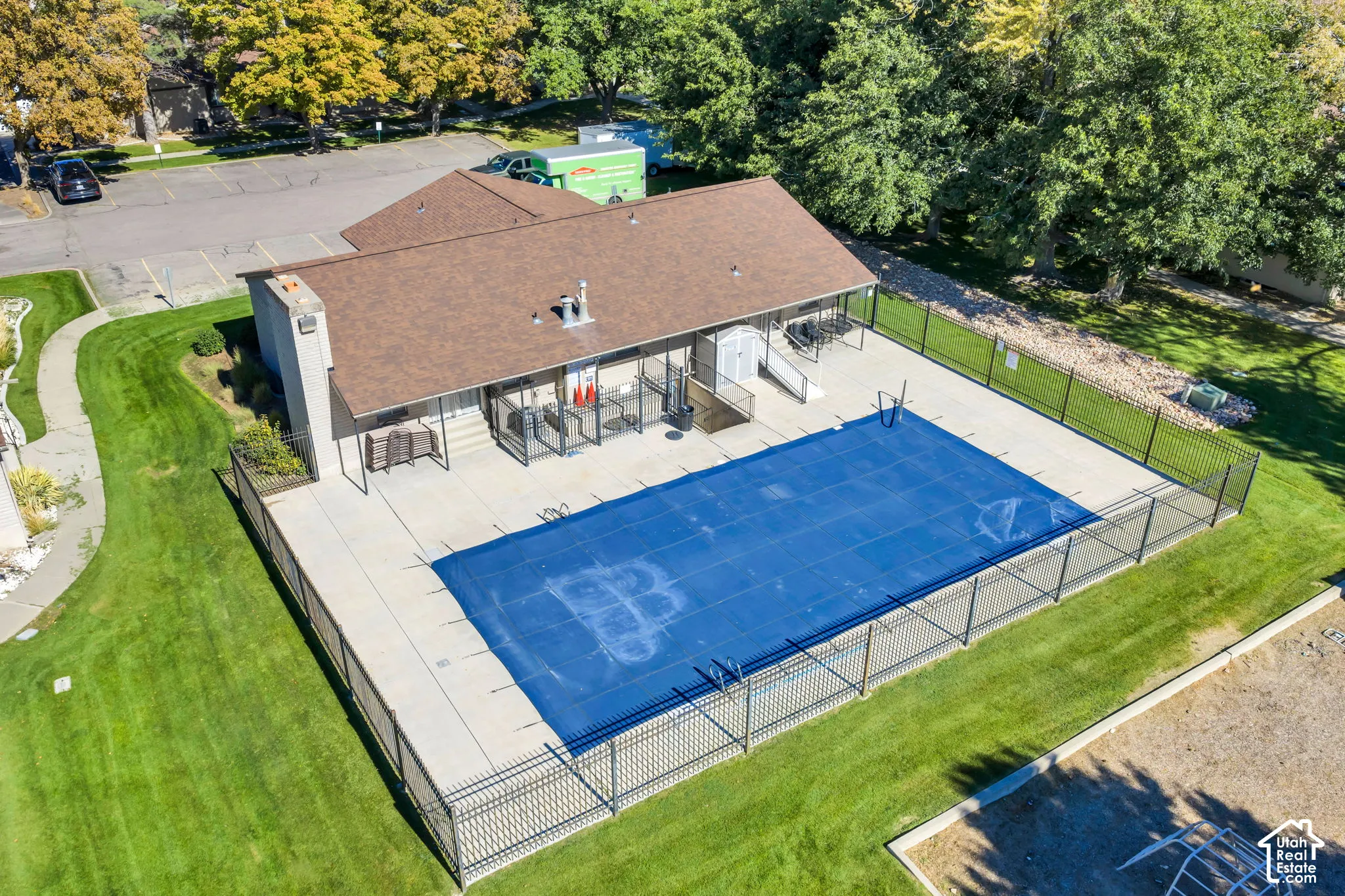 Exterior swimming pool featuring a concrete deck and full perimeter metal fencing