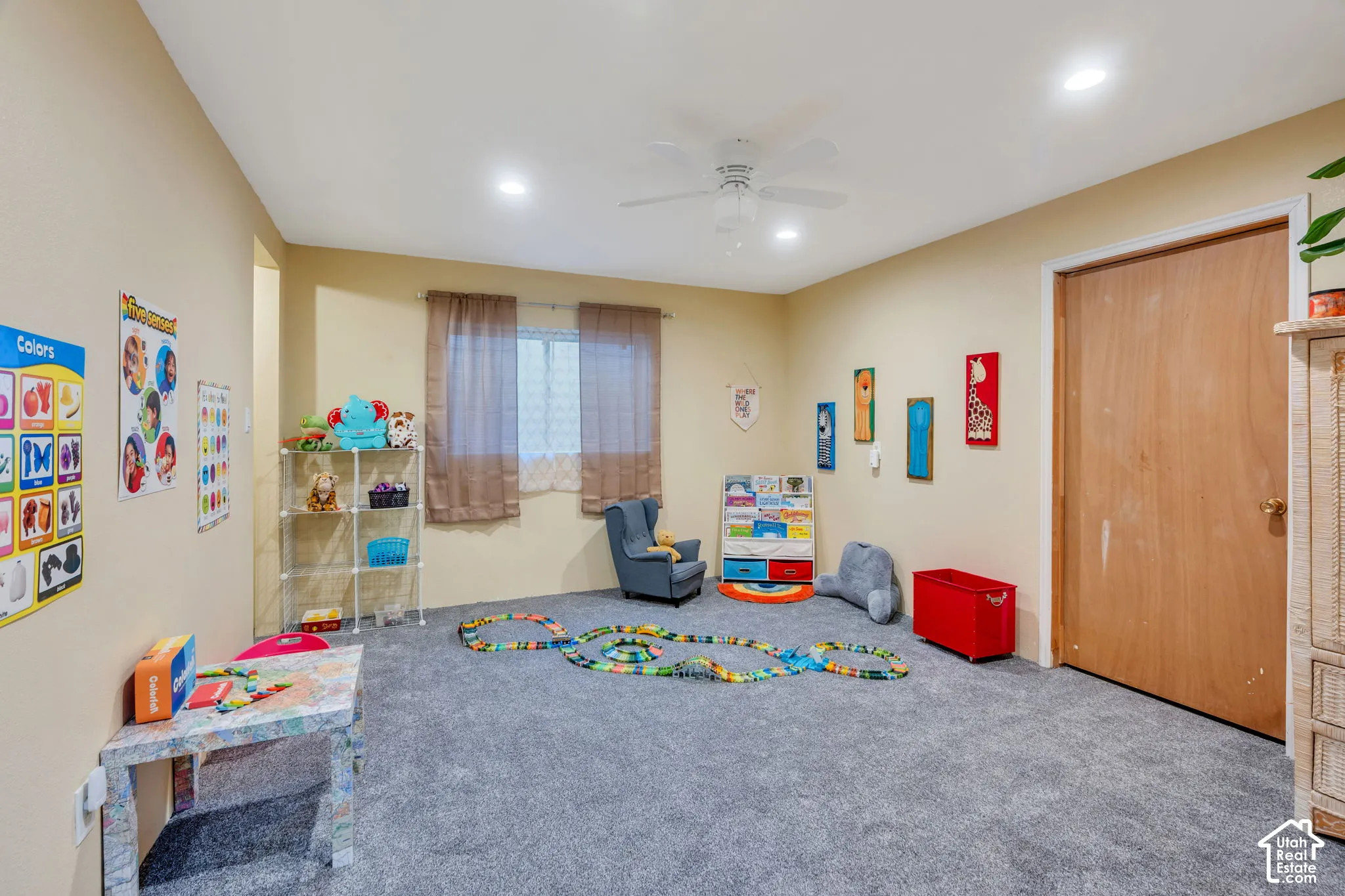 Interior room featuring wall-to-wall carpeting, recessed ceiling lighting, a white ceiling fan, and a wood-finish interior door