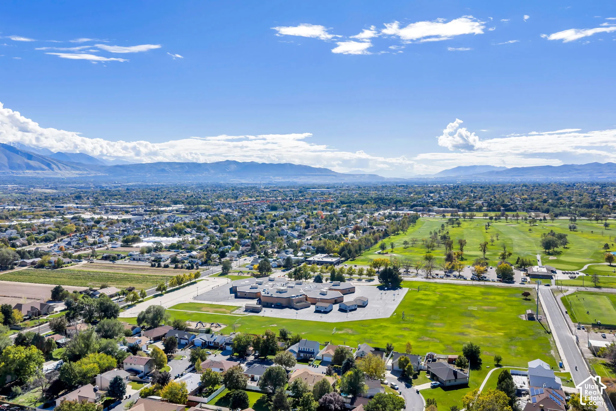 Aerial perspective featuring expansive mountain topography and large-scale manicured green space