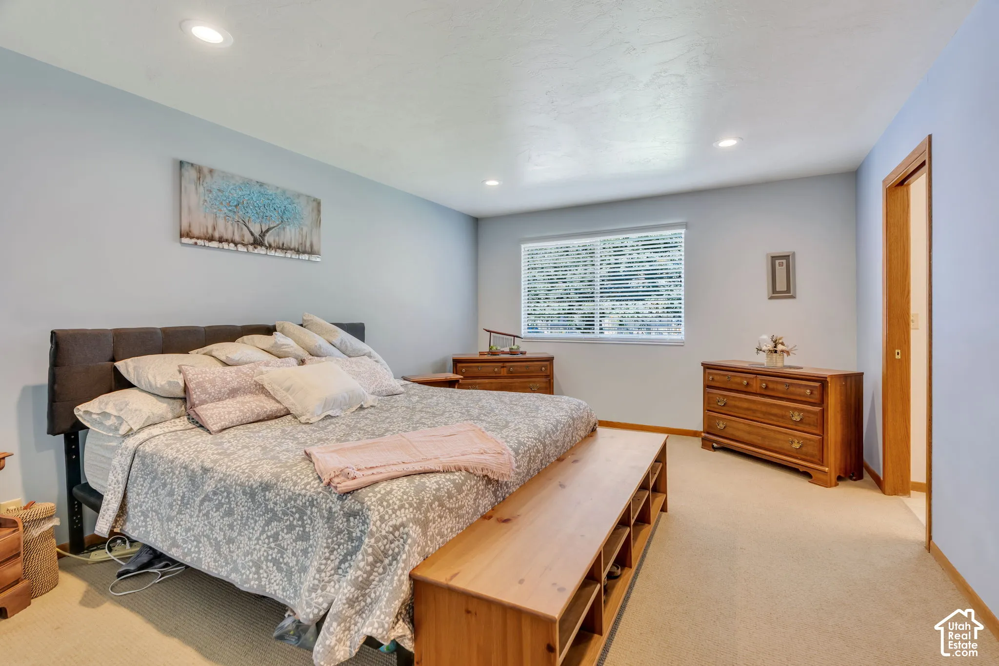 Spacious room featuring neutral carpeting, recessed lighting, and a single-pane window with horizontal blinds