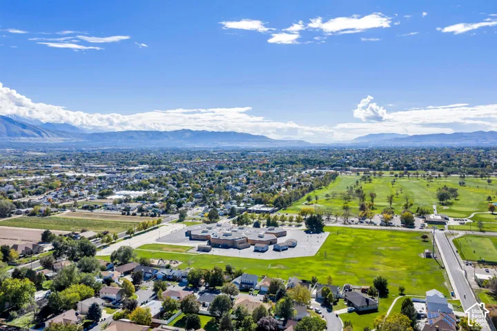Aerial perspective featuring expansive mountain topography and large-scale manicured green space