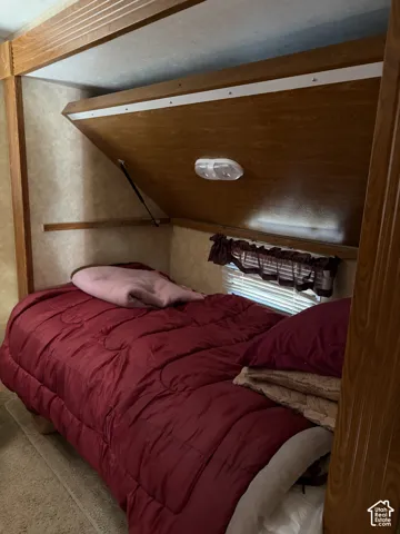 Built-in fold-down platform, wood-finish framing, integrated task lighting, and horizontal window blinds