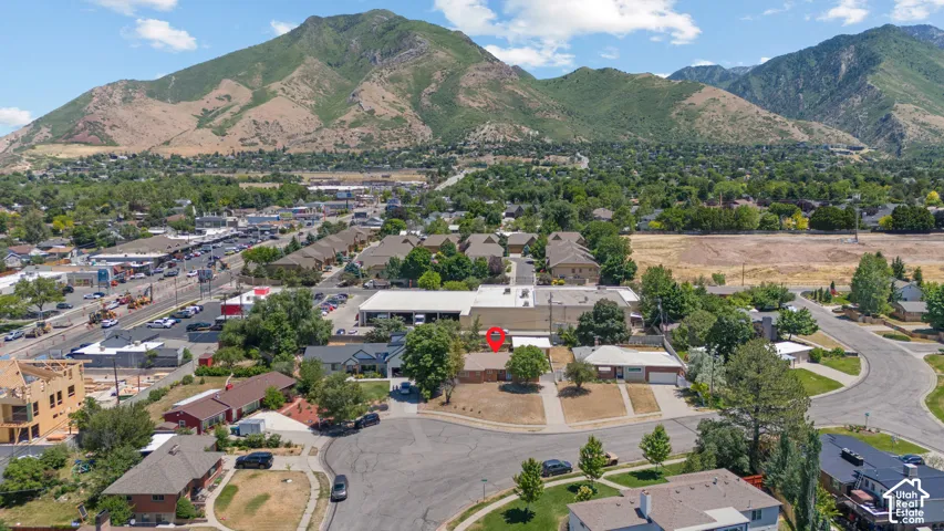 Aerial perspective highlighting the property location, suburban street configuration, and mountain backdrop