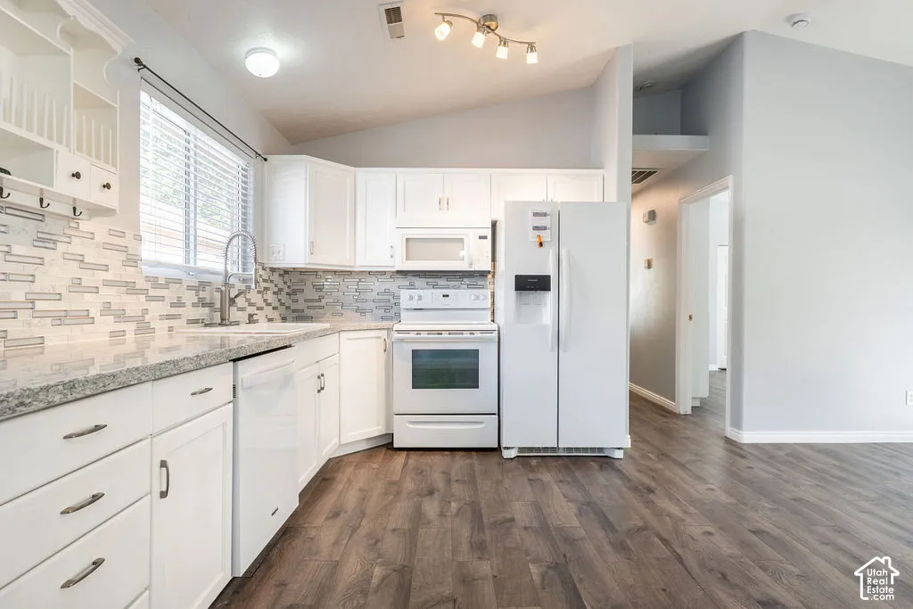 Kitchen featuring white cabinetry, stone-surface countertops, mosaic tile backsplash, wood-finish flooring, and vaulted ceilings