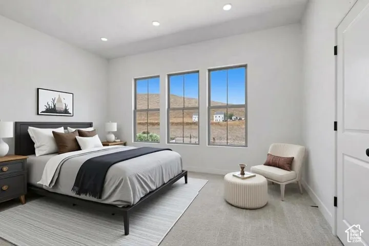 Interior space featuring neutral wall tones, recessed lighting, triple window configuration with mountain scenery, and wall-to-wall carpeting