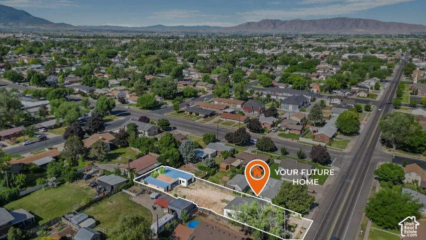 Aerial perspective featuring a rectangular lot with mature trees and a mountain range backdrop