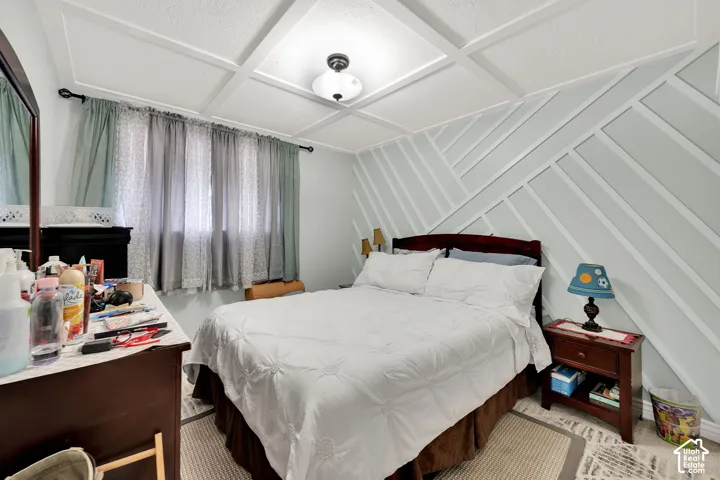 Custom ceiling grid millwork featuring a central dome flush-mount light fixture and geometric accent wall molding