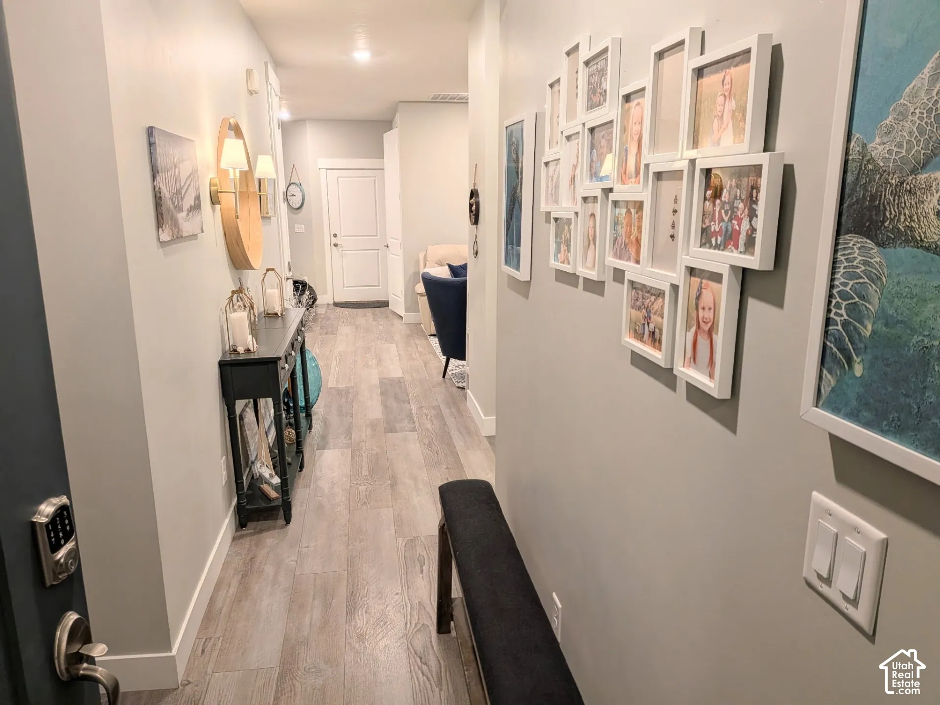 Entryway featuring wood-finish flooring, neutral wall tones, recessed lighting, and a six-panel door