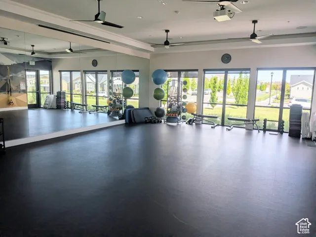 Large mirrored wall, resilient rubber flooring, expansive floor-to-ceiling windows, and recessed ceiling fans