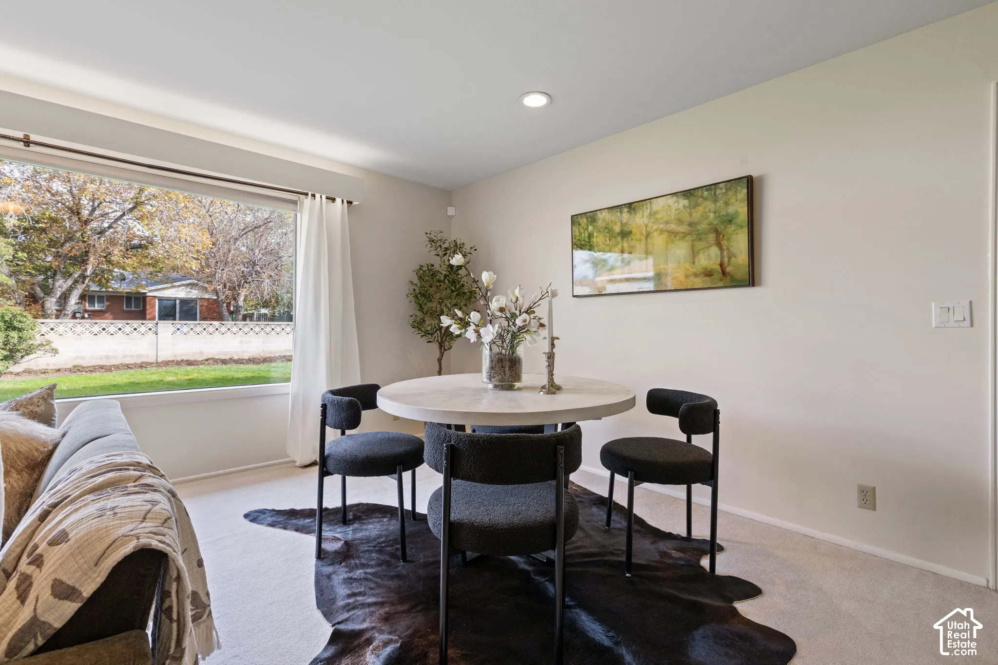Neutral-toned room featuring a large picture window, recessed lighting, and wall-to-wall carpeting