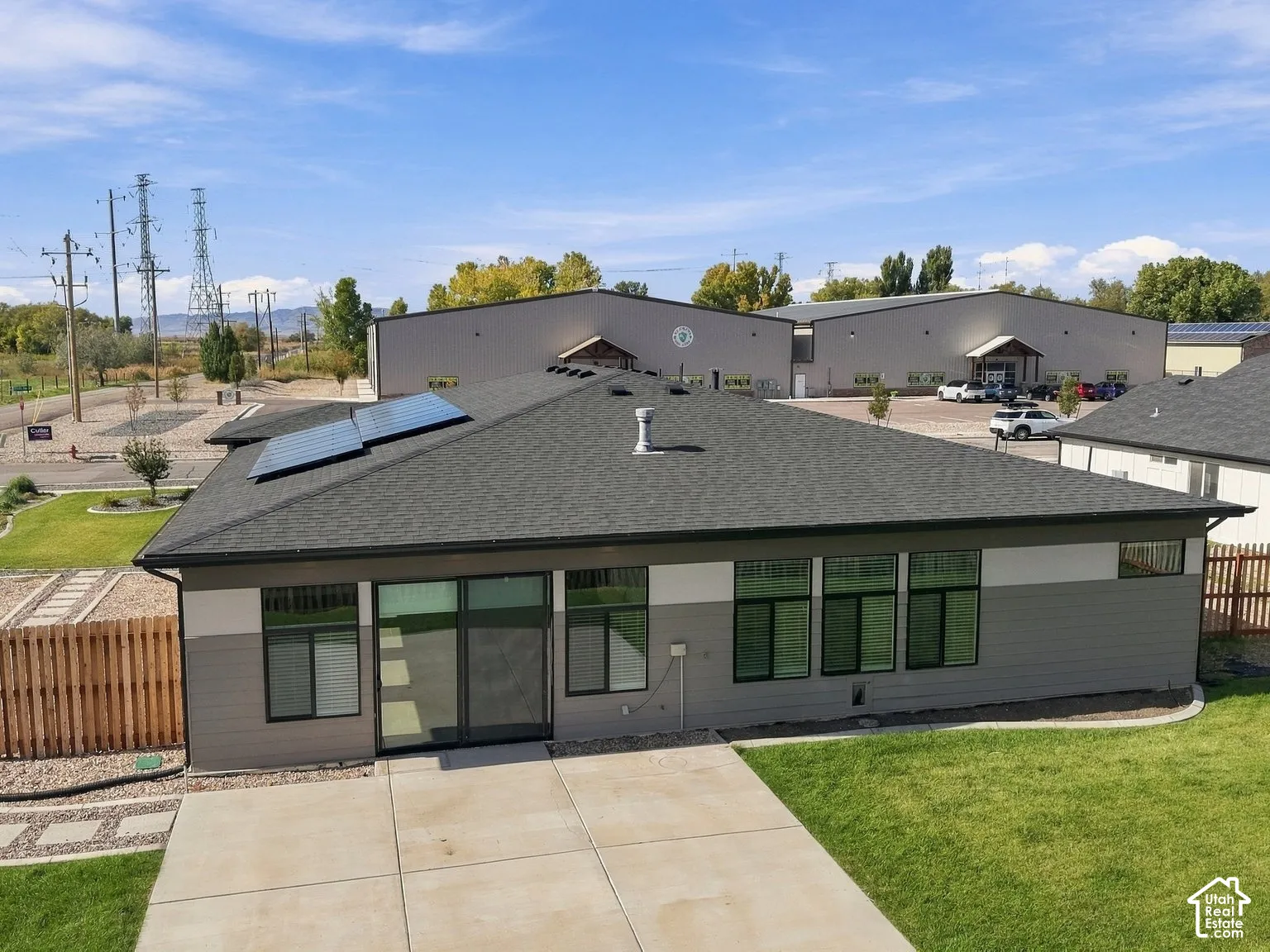 Single-story exterior featuring a grey lap siding fa
