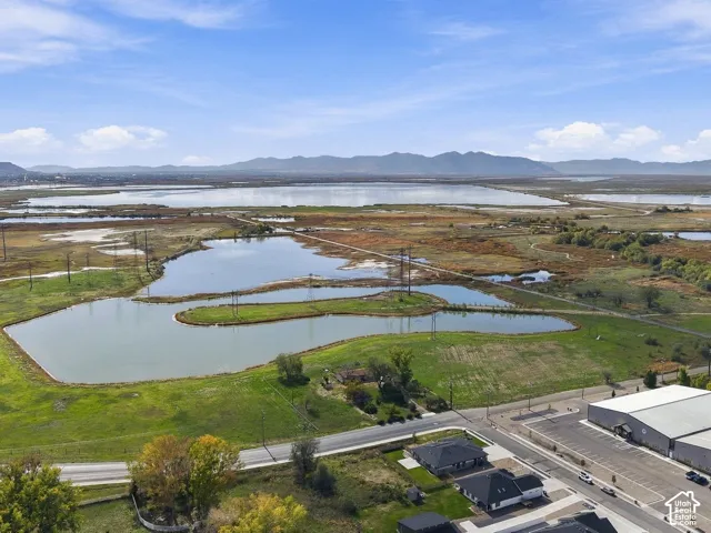 Expansive acreage featuring water frontage, open terrain, and mountain scenery