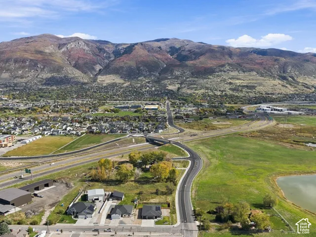 Aerial perspective featuring extensive mountain range backdrop, open terrain, and proximity to regional infrastructure
