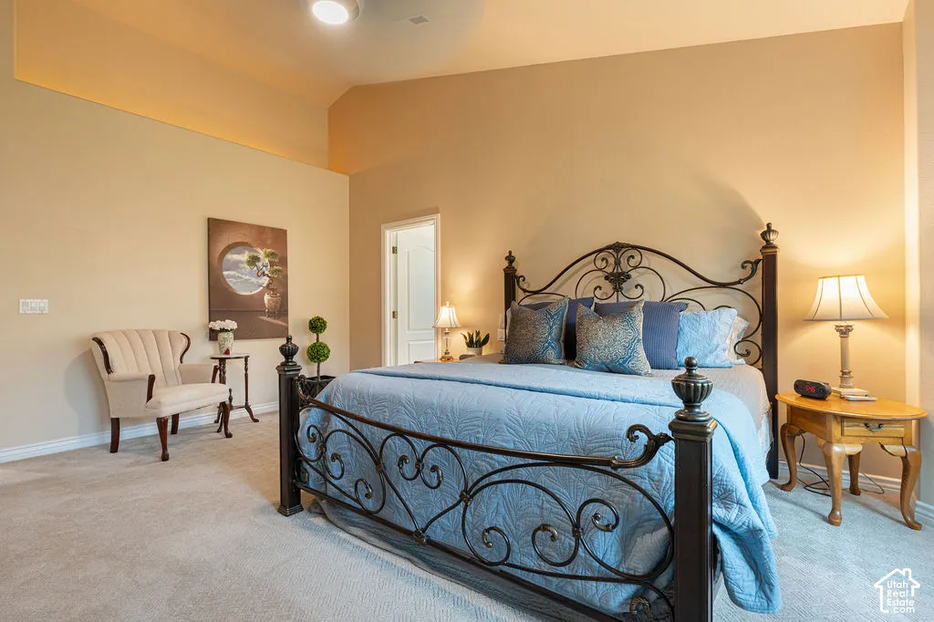 Spacious room featuring vaulted ceilings and carpeted flooring