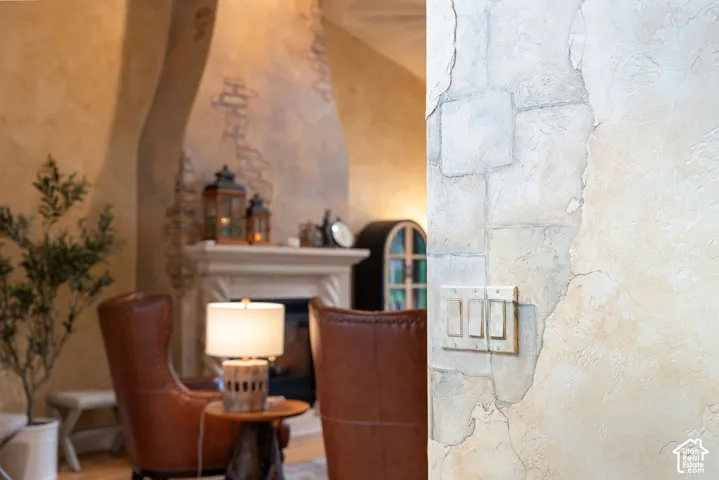 Troweled plaster wall finish with stone-texture detailing and a full-height fireplace surround featuring decorative masonry elements