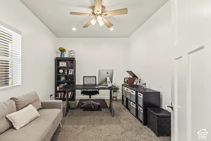 Interior room featuring neutral wall paint, carpeting, recessed lighting, and a ceiling fan with integrated light fixture