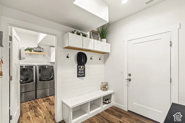 Built-in mudroom bench with open cubbies, white shiplap wall detail, and upper cabinetry