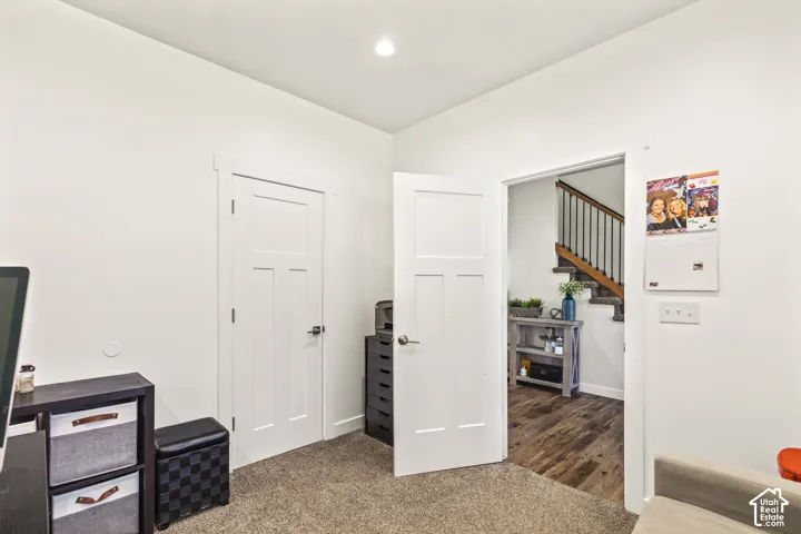 Interior space featuring recessed lighting, wall-to-wall carpeting, and shaker-style panel doors with metallic hardware