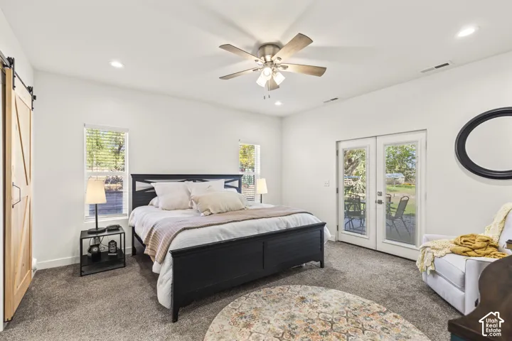 Neutral interior featuring recessed lighting, a ceiling fan, carpeted flooring, a sliding wood-finish door, and glass-paned doors with exterior access