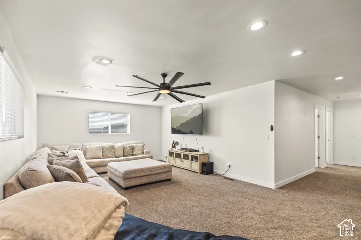 Spacious interior featuring recessed lighting, a multi-blade ceiling fan, and wall-to-wall carpeting