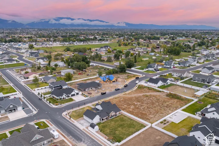 Aerial perspective of a residential development featuring paved street infrastructure and mountain scenery