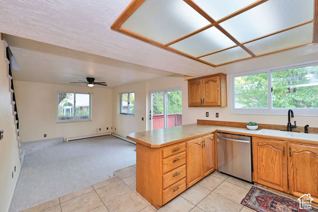 Kitchen featuring wood cabinetry, stainless steel dishwasher, integrated recessed lighting panel, and ceramic tile flooring