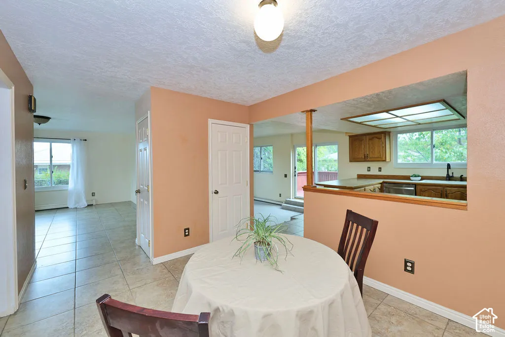 Tile flooring, kitchen pass-through, recessed lighting, and multi-panel interior doors