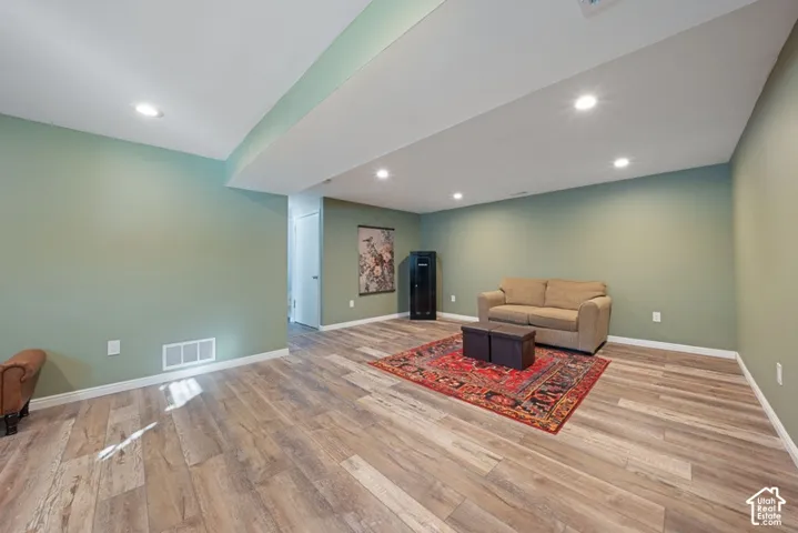 Interior room featuring wood-finish plank flooring, recessed lighting, and soft green painted walls