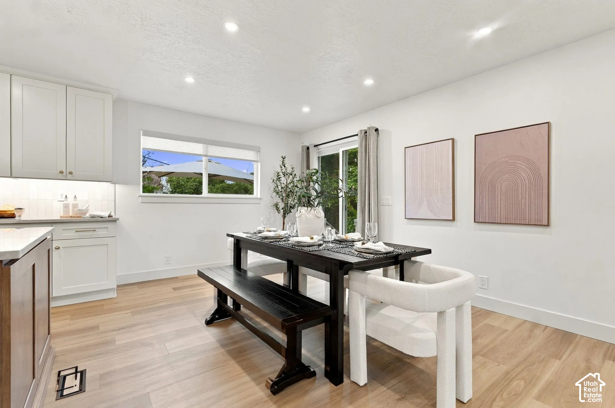 Kitchen featuring white shaker-style cabinetry, wood-finish flooring, recessed lighting, and a sliding glass door