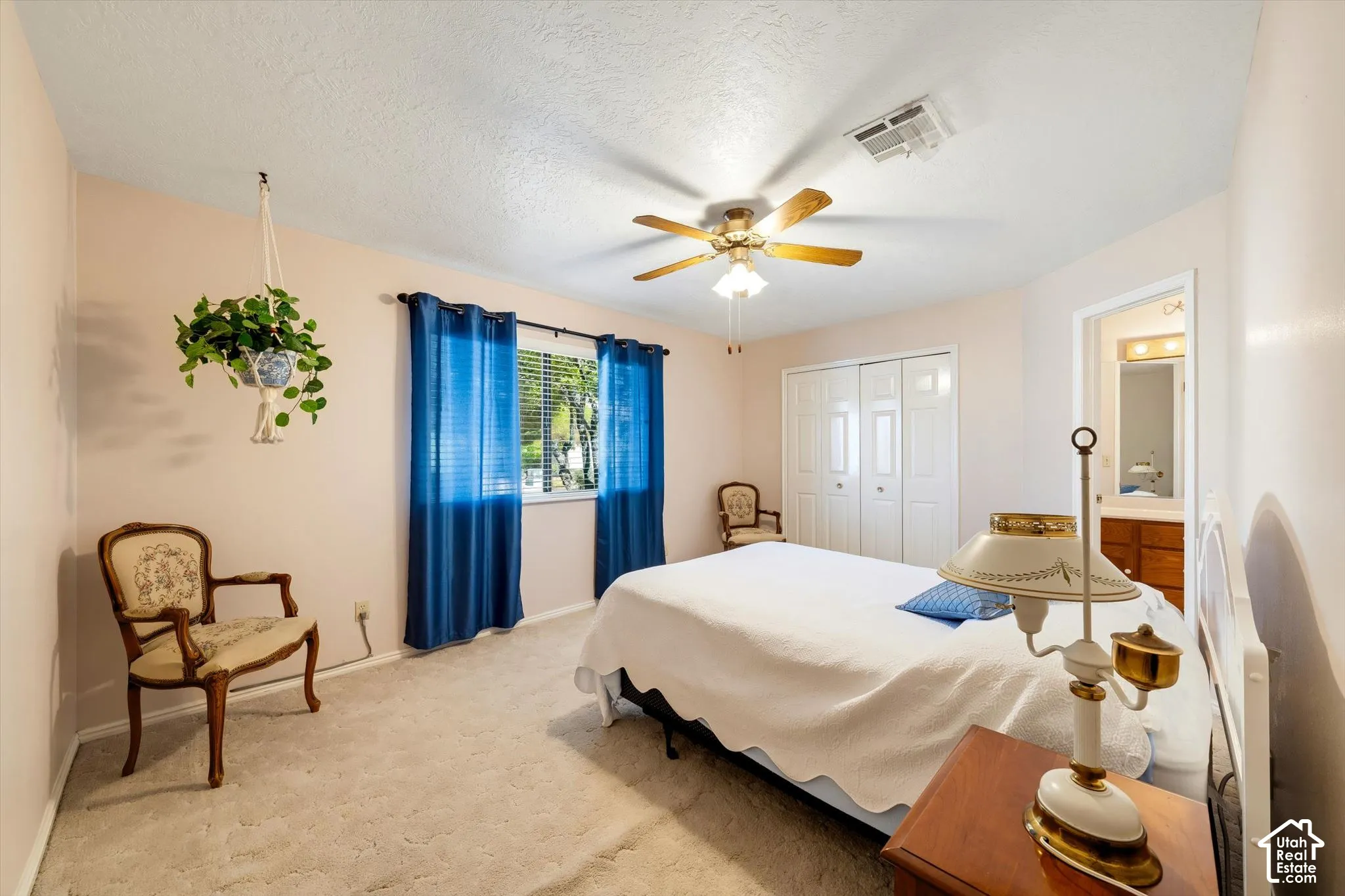 Bedroom featuring carpeting, neutral wall color, ceiling fan with light fixture, and dual-panel closet doors