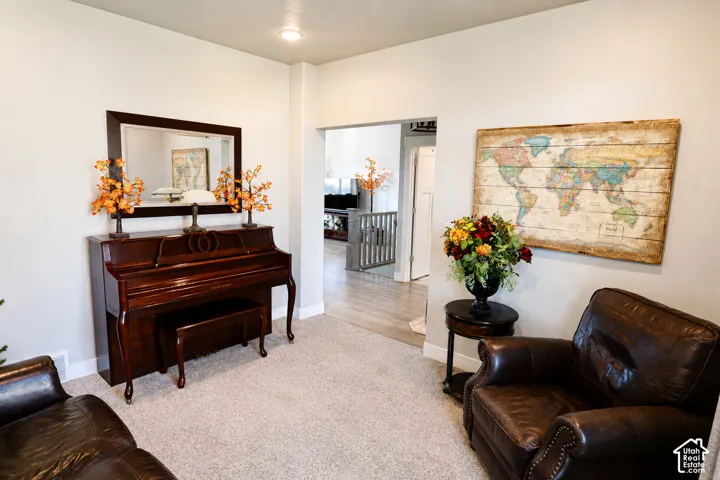 Neutral wall tones, wall-to-wall carpeting, and recessed ceiling lighting