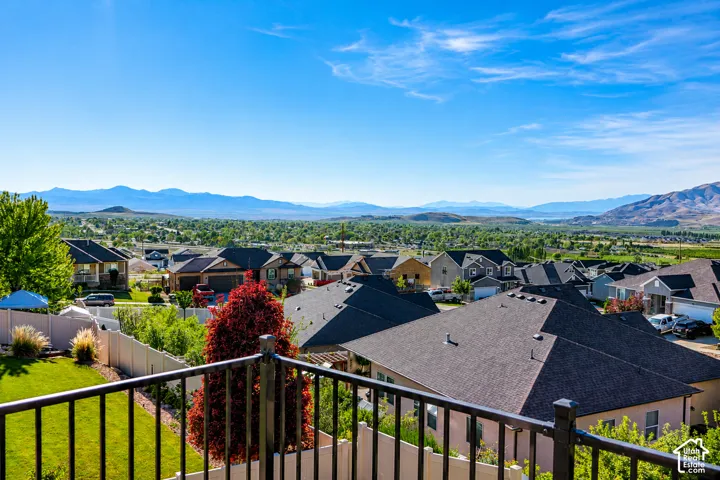 Elevated deck featuring black metal railing and expansive mountain backdrop